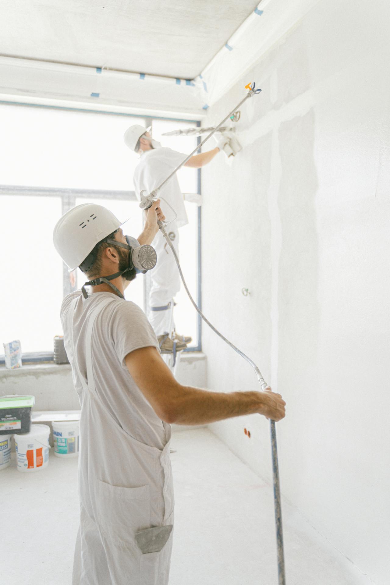 VL Painting crew spray-painting a wall